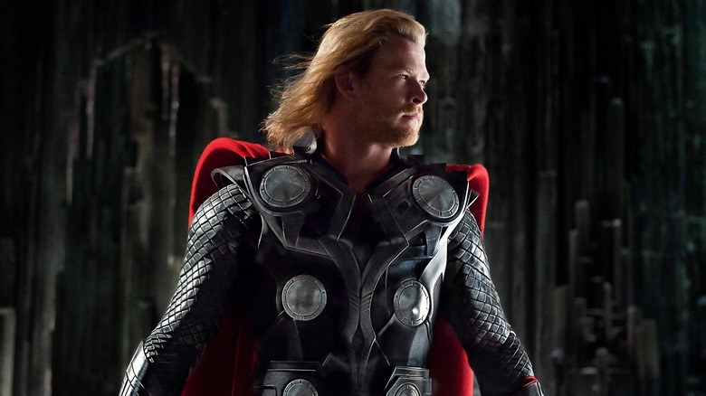 Chris Hemsworth as Thor holding his hammer by his side in Thor