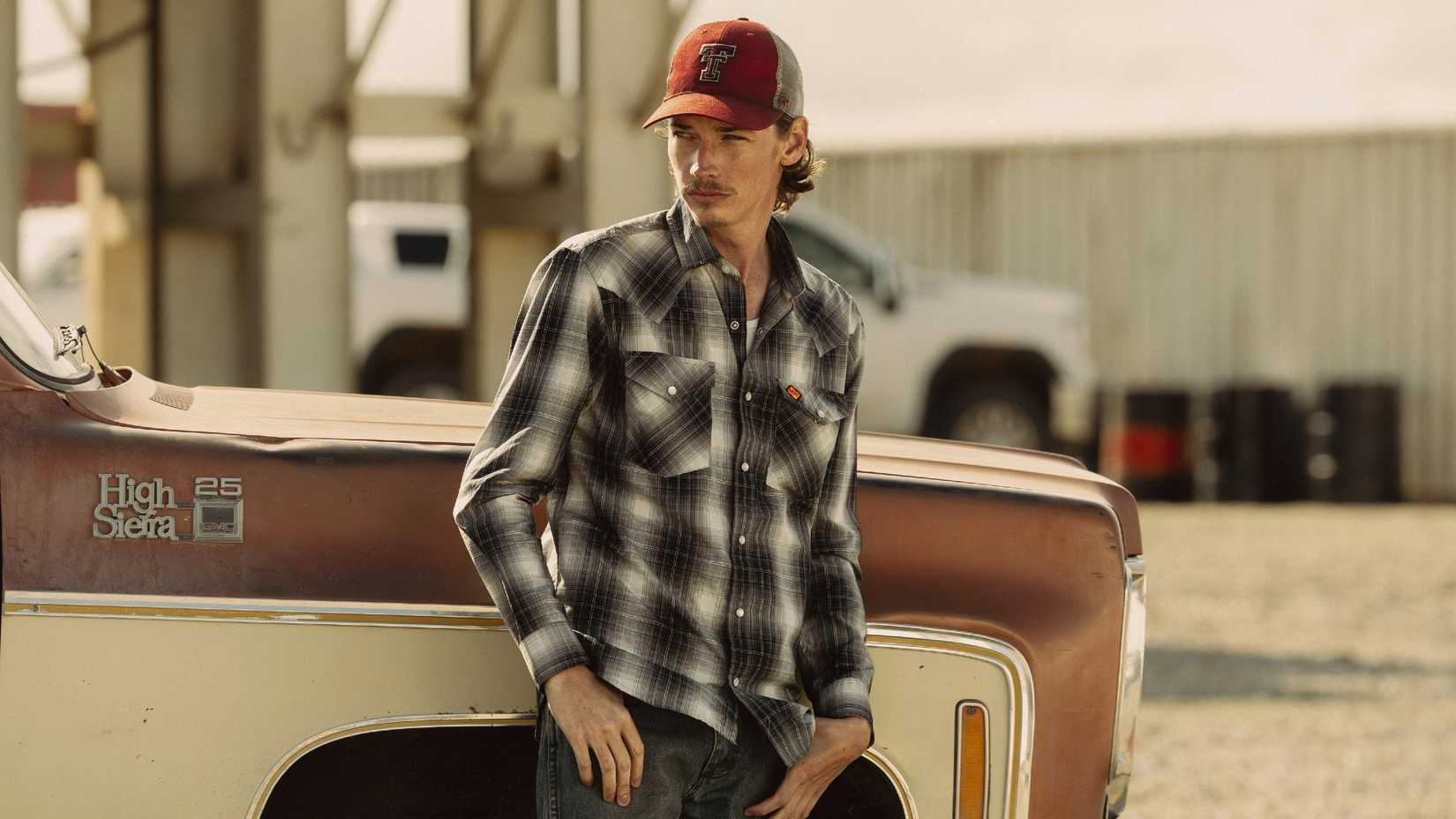 Jacob Lofland as Cooper leaning against a truck in Landman season 2