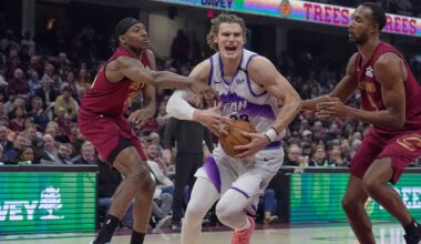 Utah Jazz forward Lauri Markkanen, center, drives between Cleveland Cavaliers forward Nae'qwan Tomlin, left, and center Evan Mobley, right, in the first half of an NBA basketball game in Cleveland, Monday, Jan. 12, 2026. (AP Photo/Sue Ogrocki)