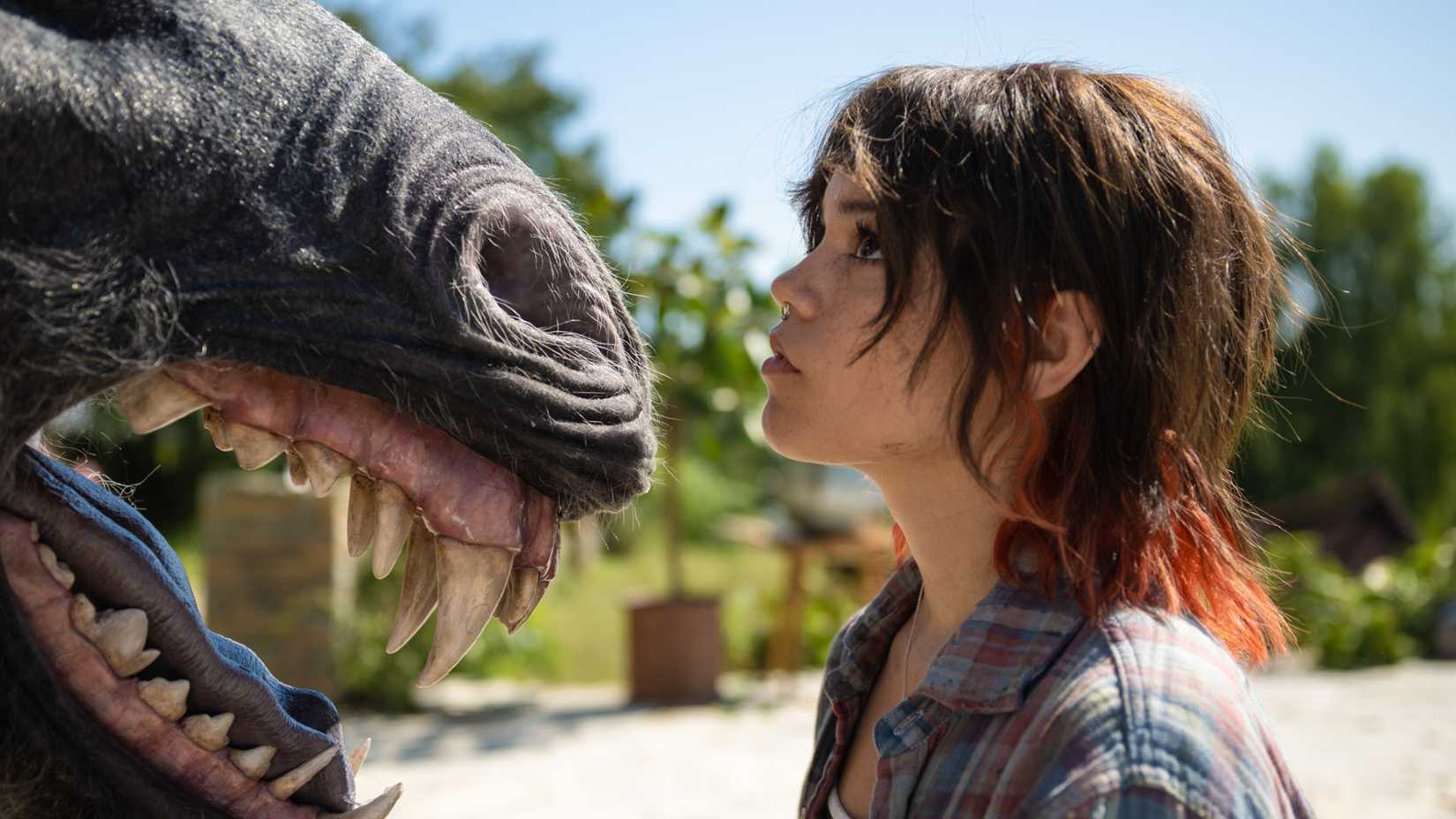 Jenna Ortega looking up at an angry unicorn in Death of a Unicorn