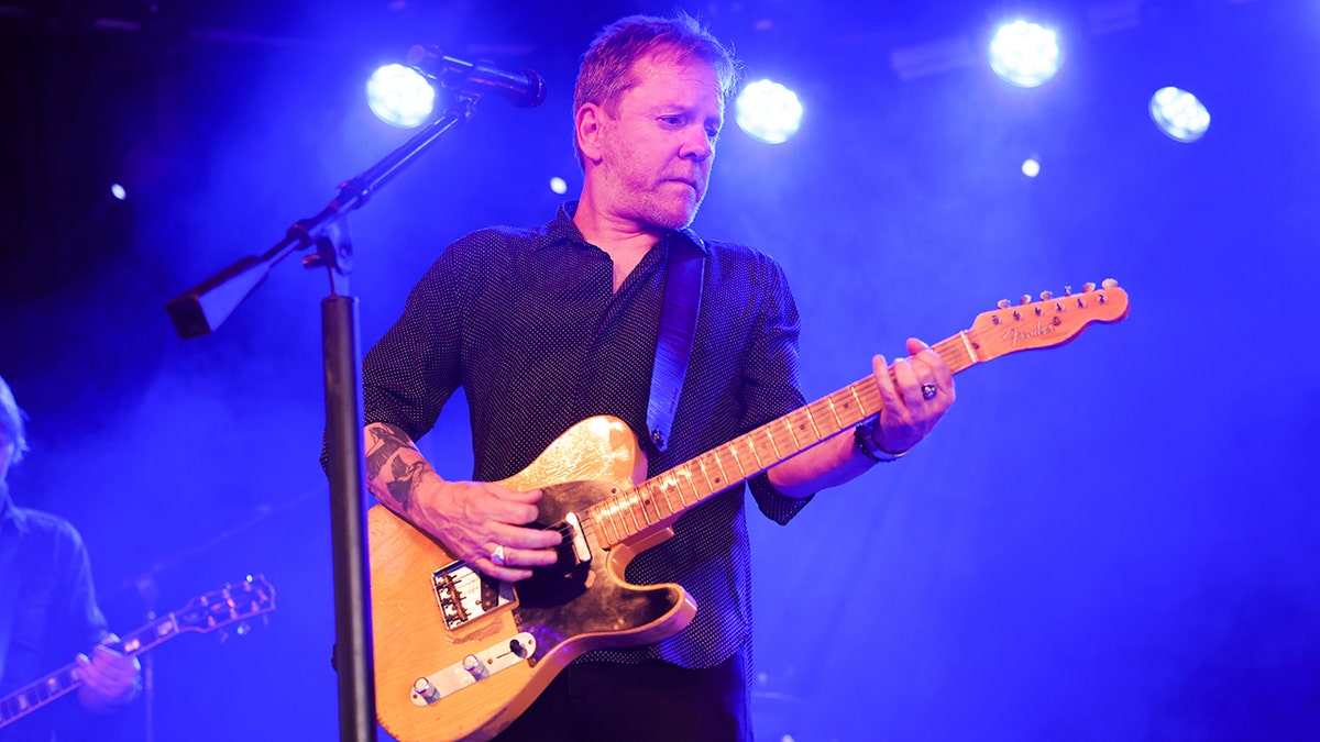 Kiefer Sutherland performing on stage in Stockholm, Sweden in August 2024.