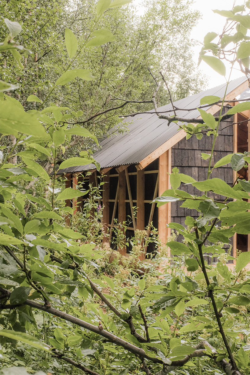 student collective builds fireplace shelter from reclaimed materials in northern norway