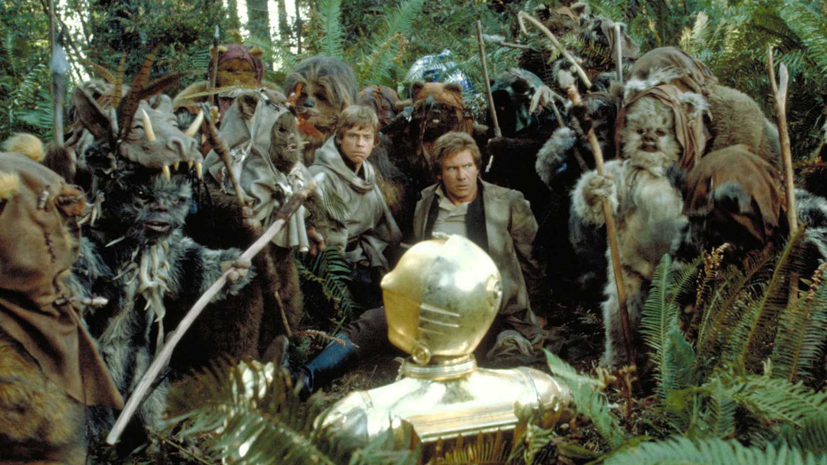 Mark Hamill and Harrison Ford in Star Wars Return of the Jedi with Ewoks on the forest of Endor