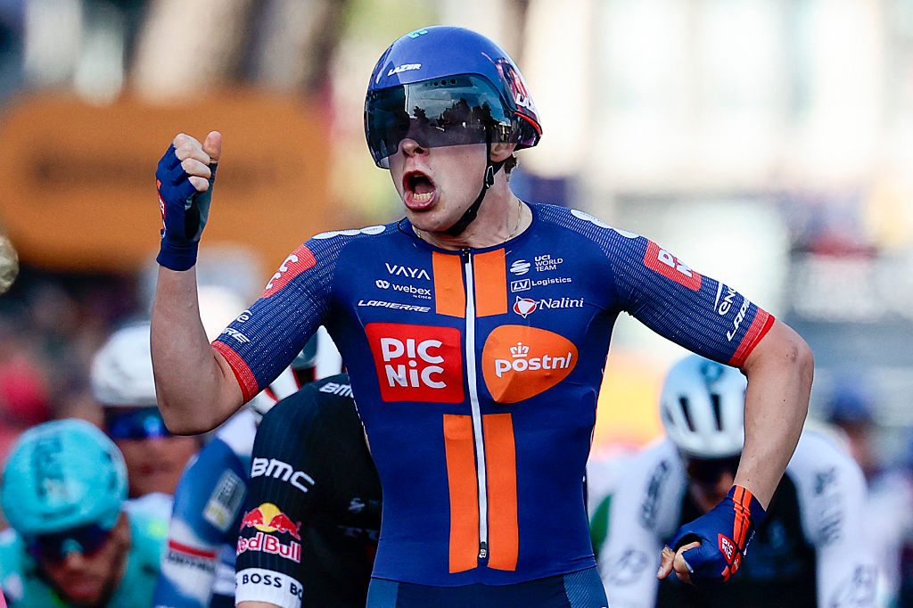 Team Picnic PostNL's Dutch rider Casper Van Uden celebrates as he crosses the finish line of the 4th stage of the 108th Giro d'Italia cycling race 189kms from Alberobello to Lecce on May 13, 2025 (Photo by Luca Bettini / AFP)