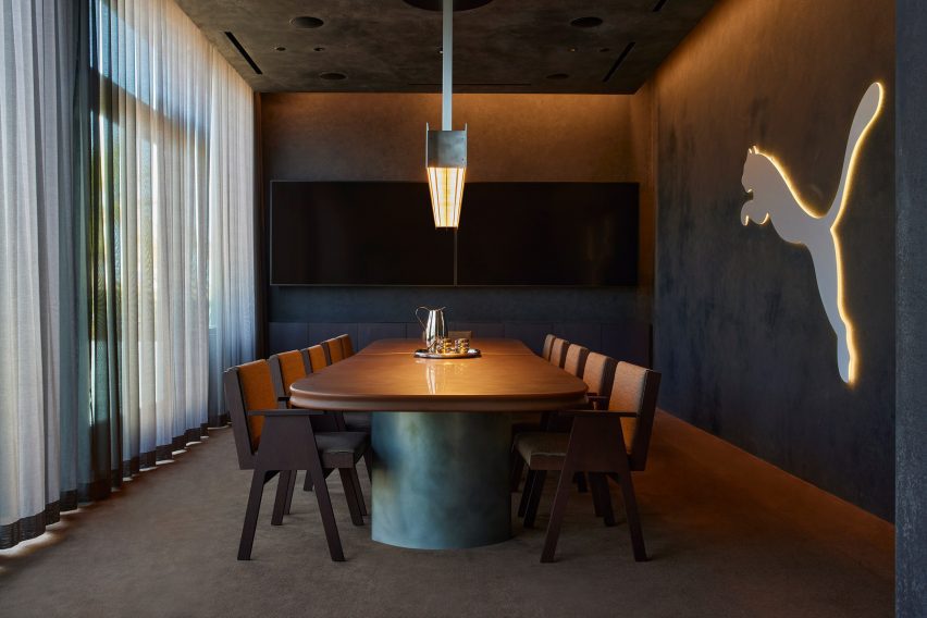 Boardroom with suede-like plastered walls and sheer curtains