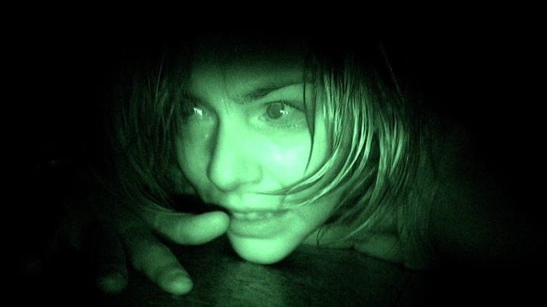 Manuela Velasco as Ángela Vidal lying on the floor in front of a night vision camera in 