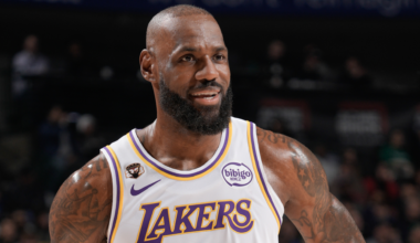 LeBron James in a Lakers jersey, smiling on a basketball court.
