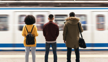 People waiting in front of a passing train.