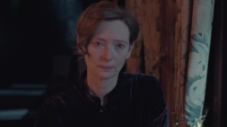 Tilda Swinton as Julie sitting with tears in her eyes in The Eternal Daughter