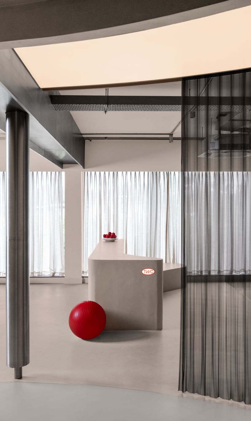 concrete and steel textures shape showroom in india organized as a continuous loop