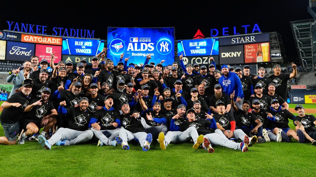 The Toronto Blue Jays celebrate on the field after beating the New York Yankees in Game 4 of baseball's American League Division Series.