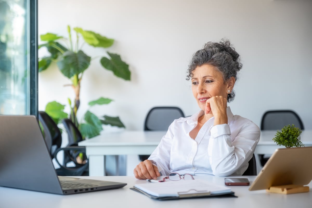 A person at a table with a laptop open.