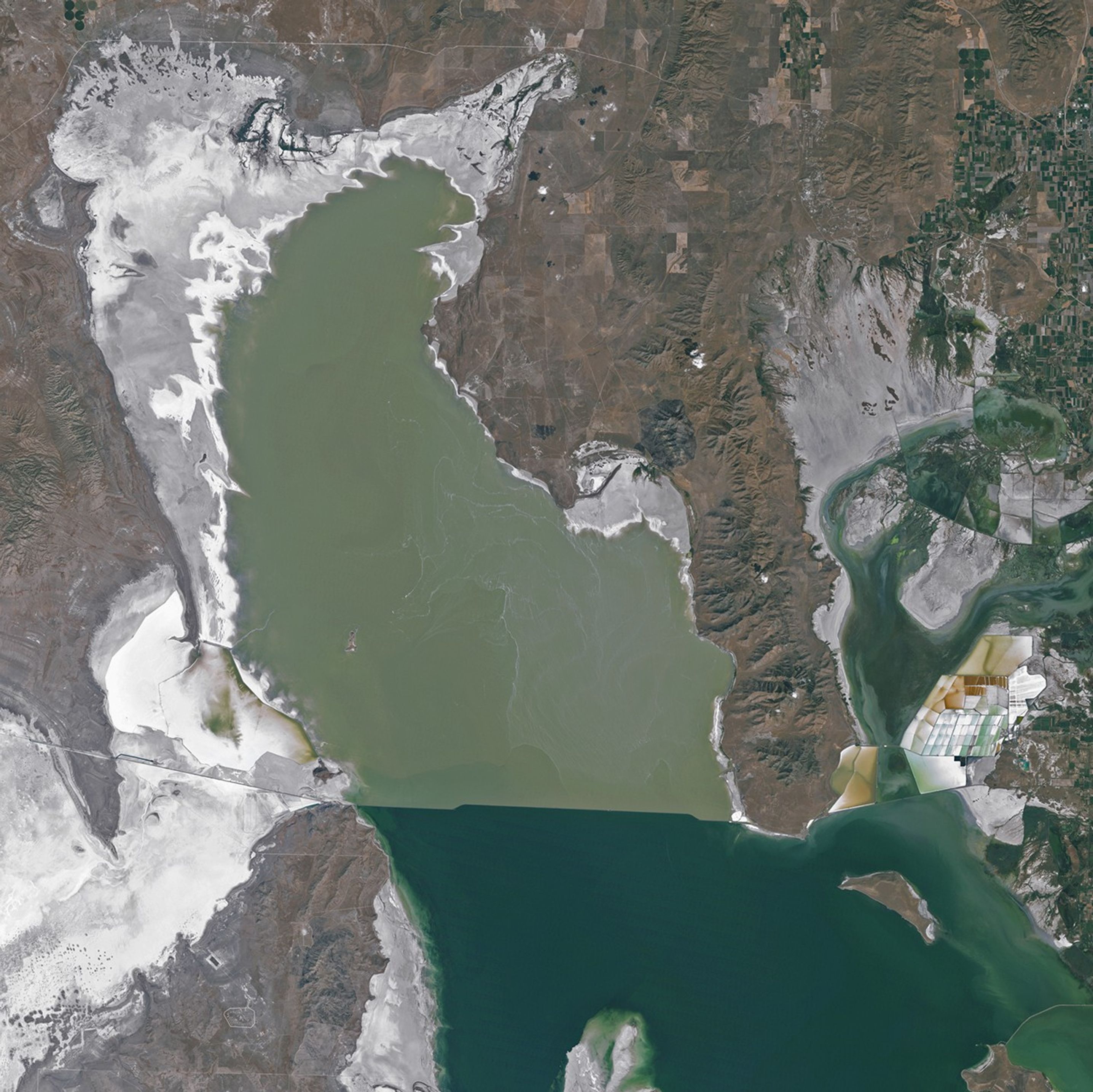A satellite image of the Great Salt Lake shoreline in 2011, when higher water levels cover areas where mounds became visible in 2025.