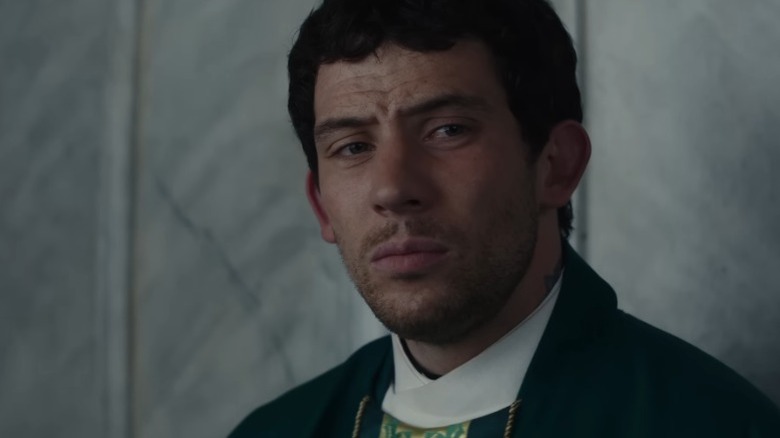 Josh O'Connor as Father Jud looking to his right with a stern expression in Wake Up Dead Man