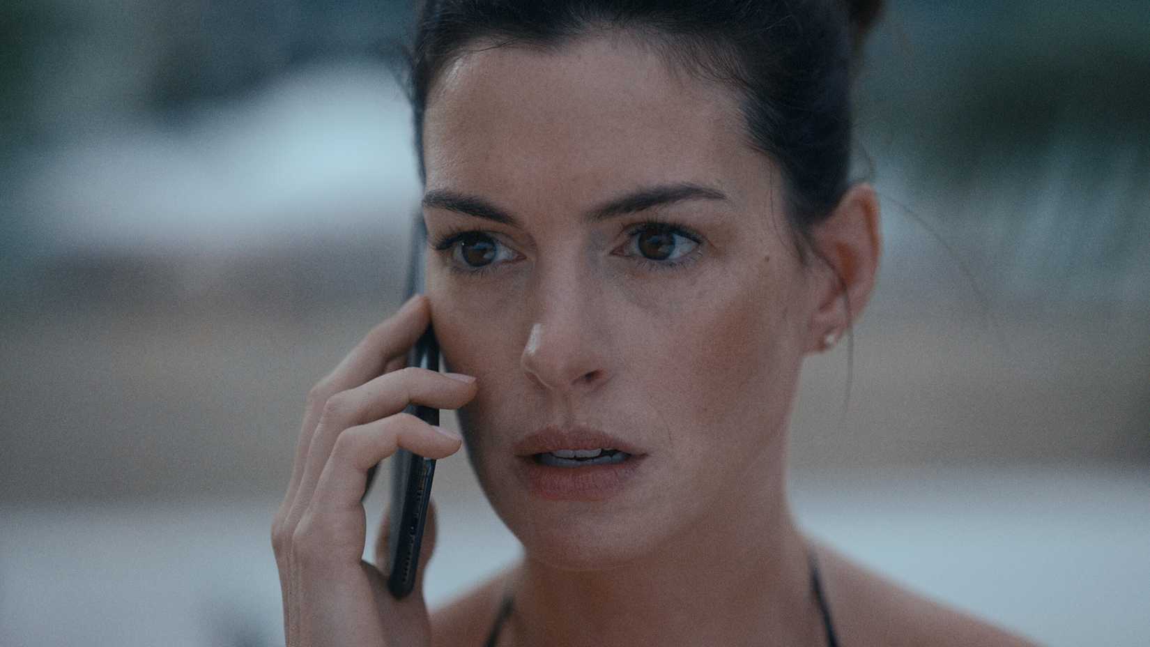 Anne Hathaway on the phone and looking serious in WeCrashed