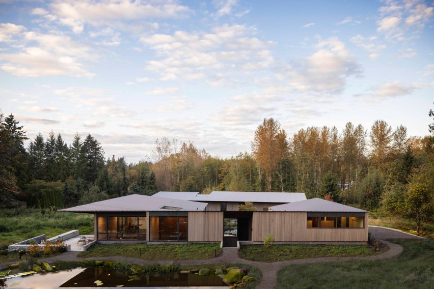 Seattle house and workshop with treeline in background