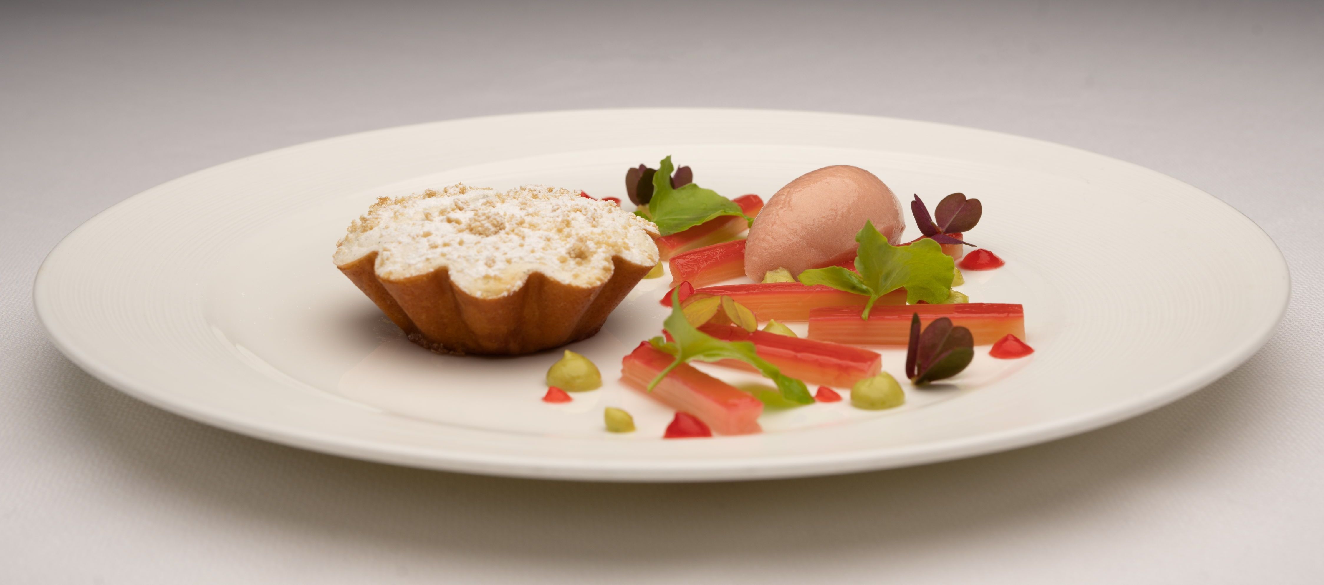 Poached rhubarb and rhubarb sorbet with a baked warm vanilla and almond mousse.