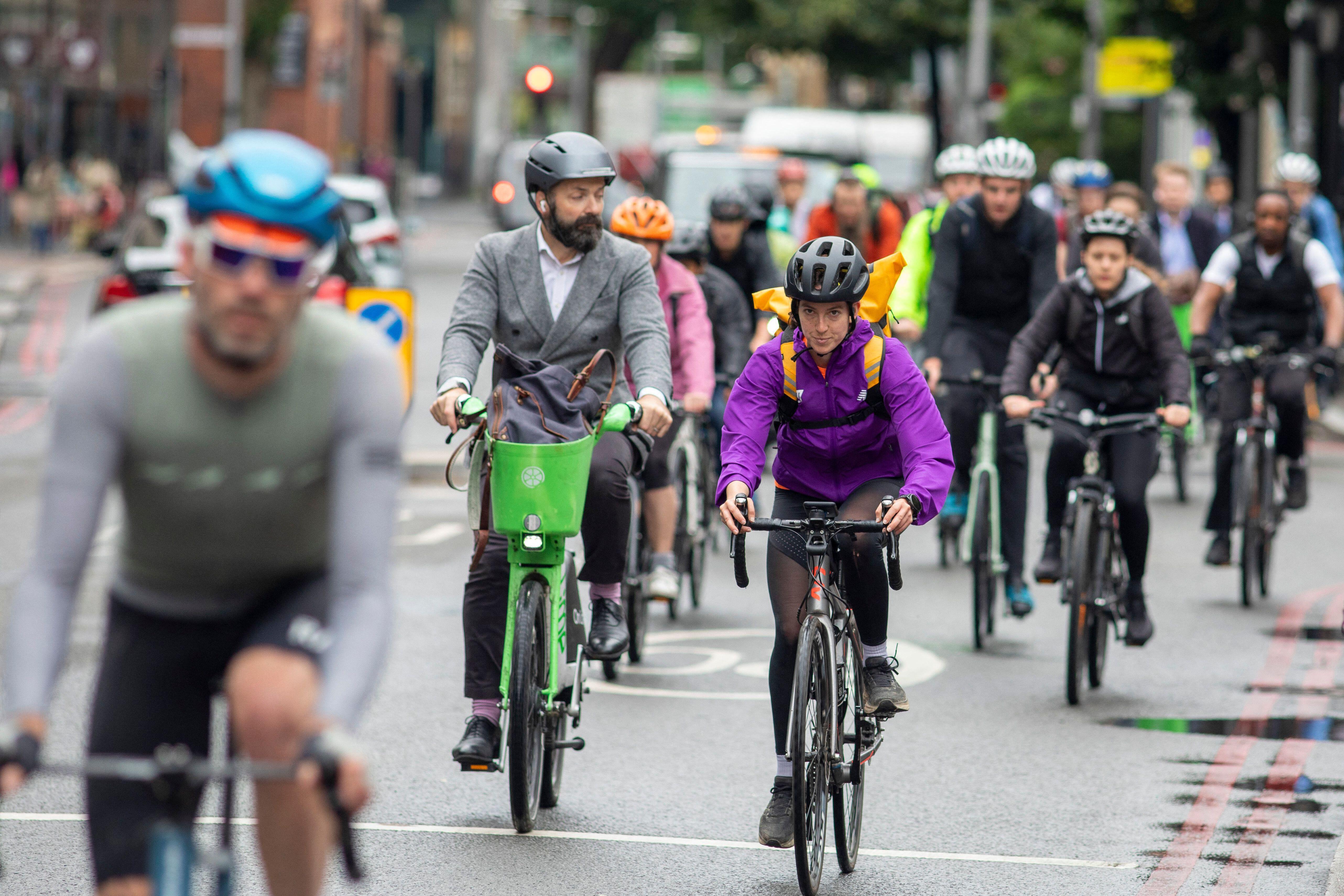 Cyclists commuting near London Bridge on a cold damp July morning in the capital city of the UK.