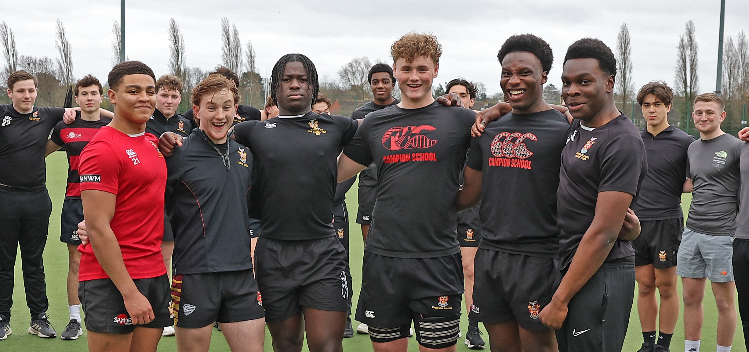 A group of male students from The Campion School Rugby team standing on a green field.