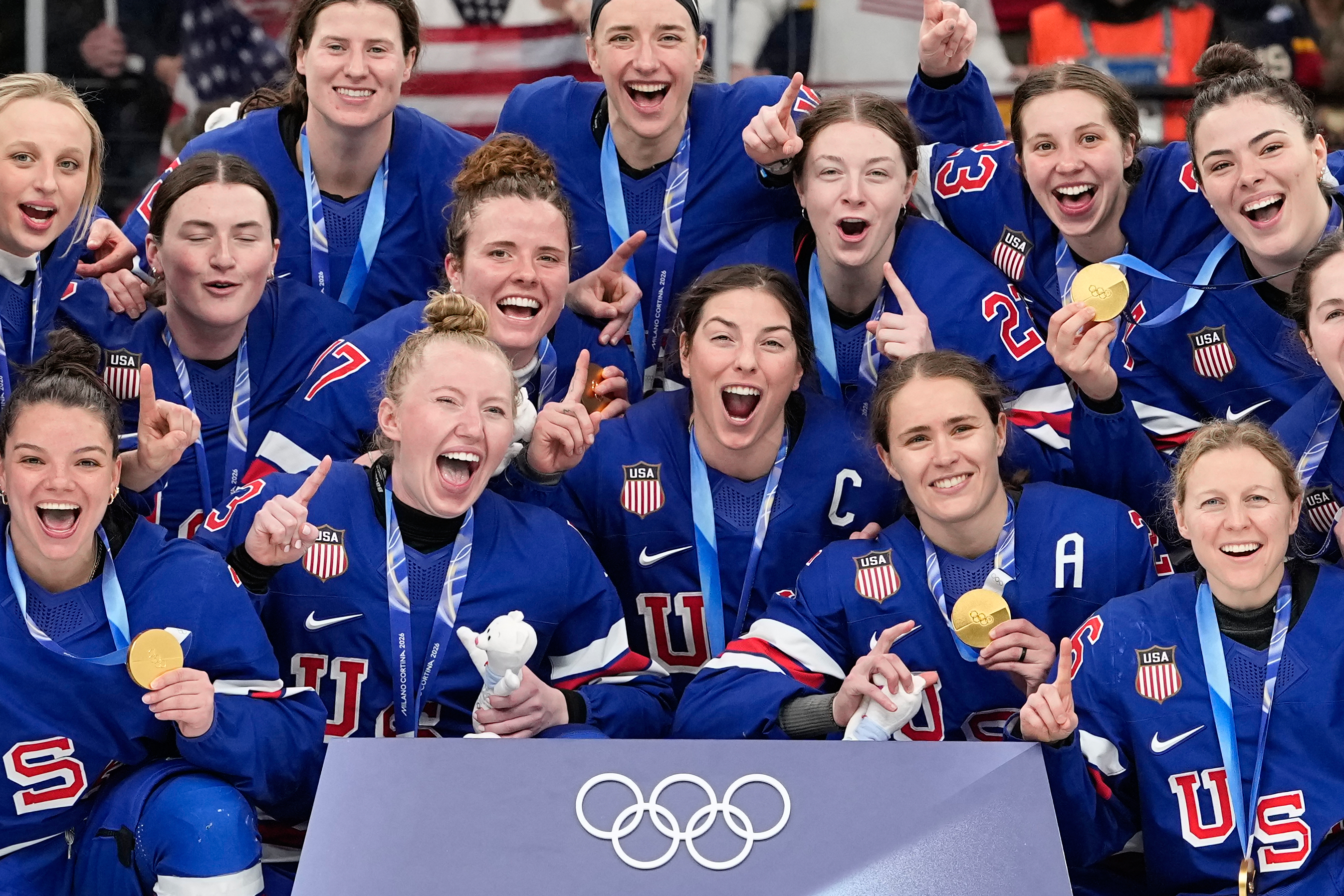 The U.S. women's ice hockey team celebrates with gold medals at the 2026 Winter Olympics.