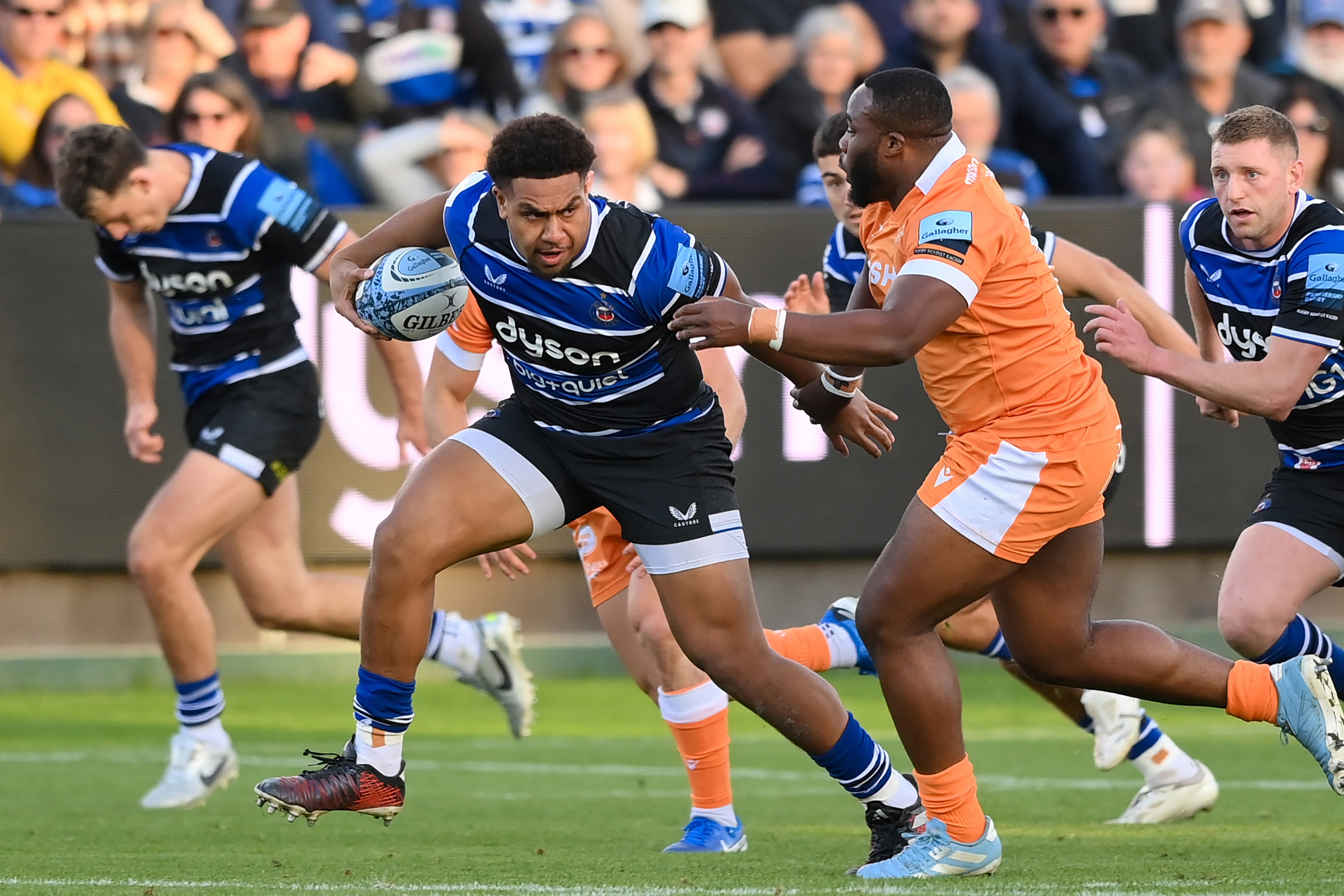 Vilikesa Sela of Bath Rugby fends Tumy Onasanya of Sale Sharks during a rugby match.