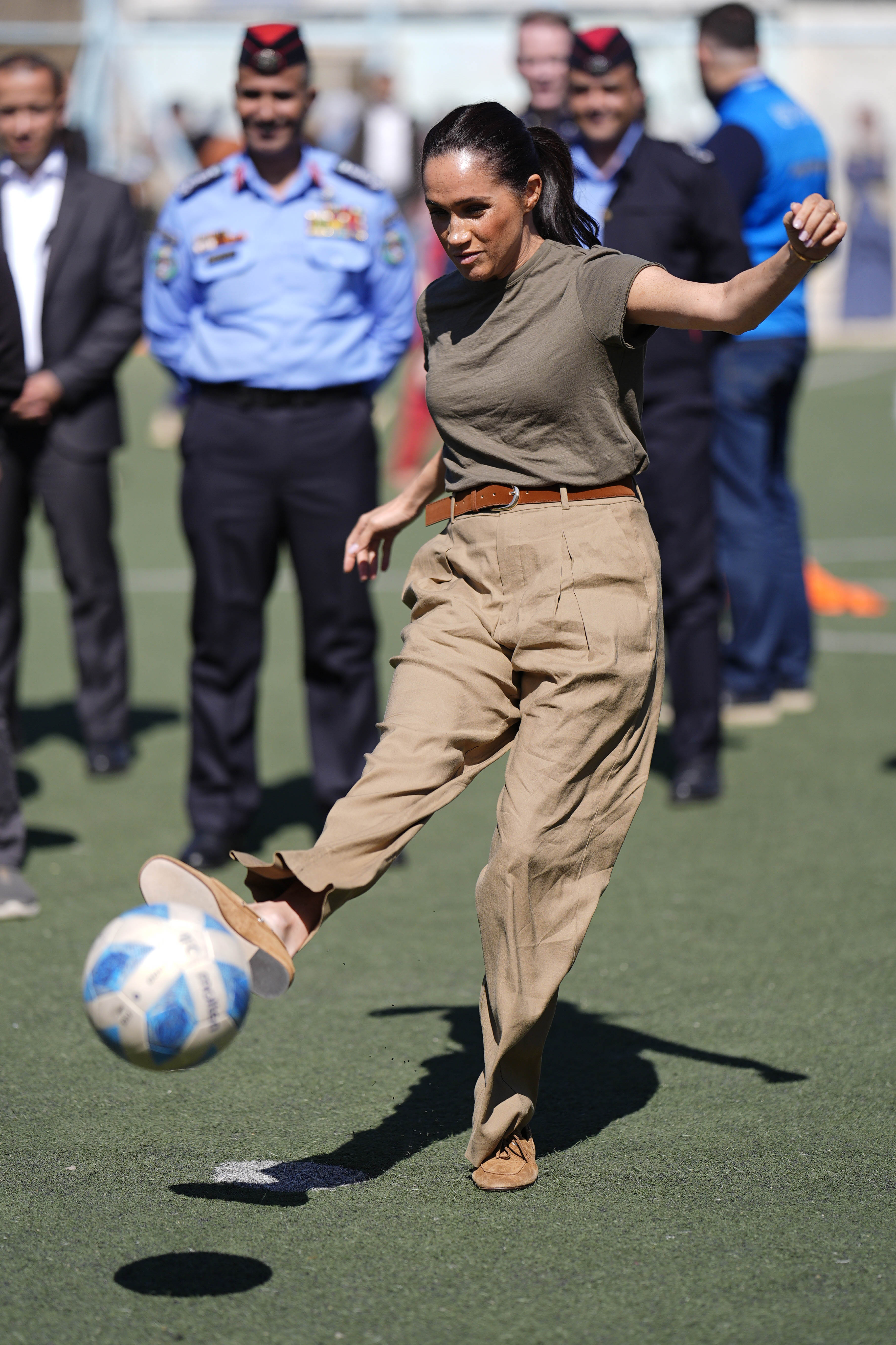 Duchess Meghan kicks a soccer ball at the Za'atari refugee camp in Jordan.
