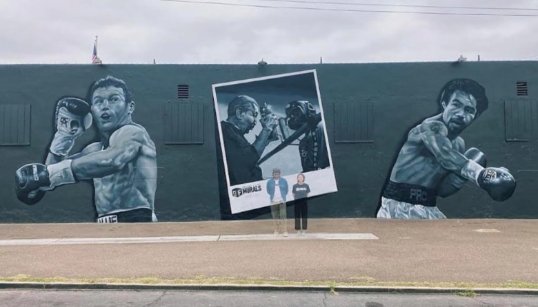 A mural includes images of two boxers, shown in their primes: Manny Pacquiao and Mexican boxing star Canelo Álvarez. A polaroid image between them shows  founder/trainer Carlos Barragan Sr. for San Diego’s House of Boxing. 
