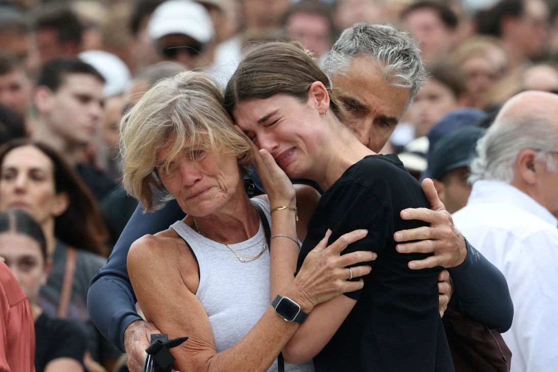 A woman pays her respects at Bondi Pavilion to victims of a shooting during a Jewish holiday celebration at Bondi Beach, in Sydney, Australia, December 15, 2025.