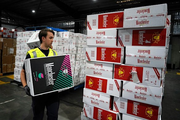 An Australian Border Force officer checks a stash of illegal cigarette imports in Melbourne.