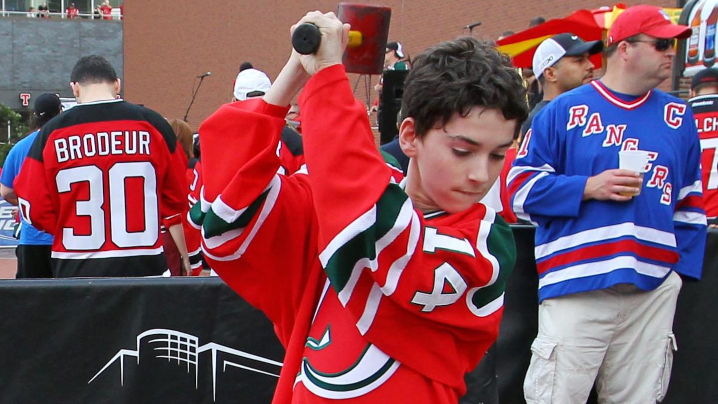 May 25, 2012; Newark, NJ, USA; A young fan hits a New York Rangers logo before game six of the 2012 Eastern Conference Finals at the Prudential Center.  Mandatory Credit: Ed Mulholland-Imagn Images