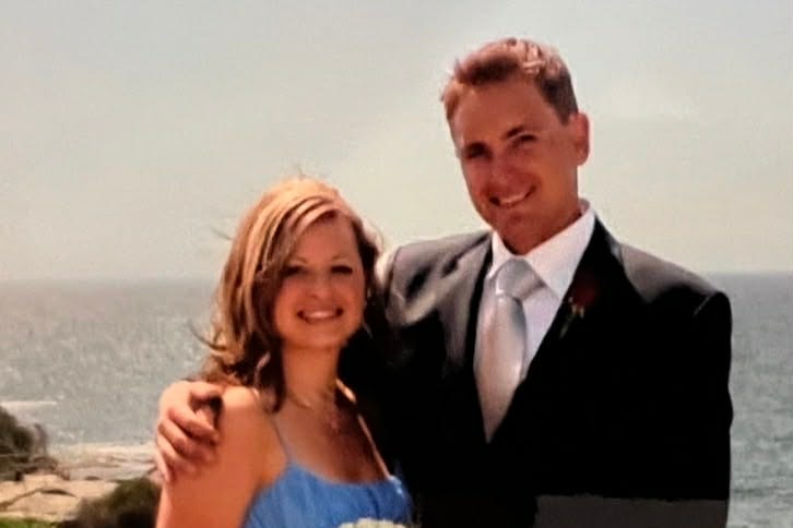 two people in formal wear smiling