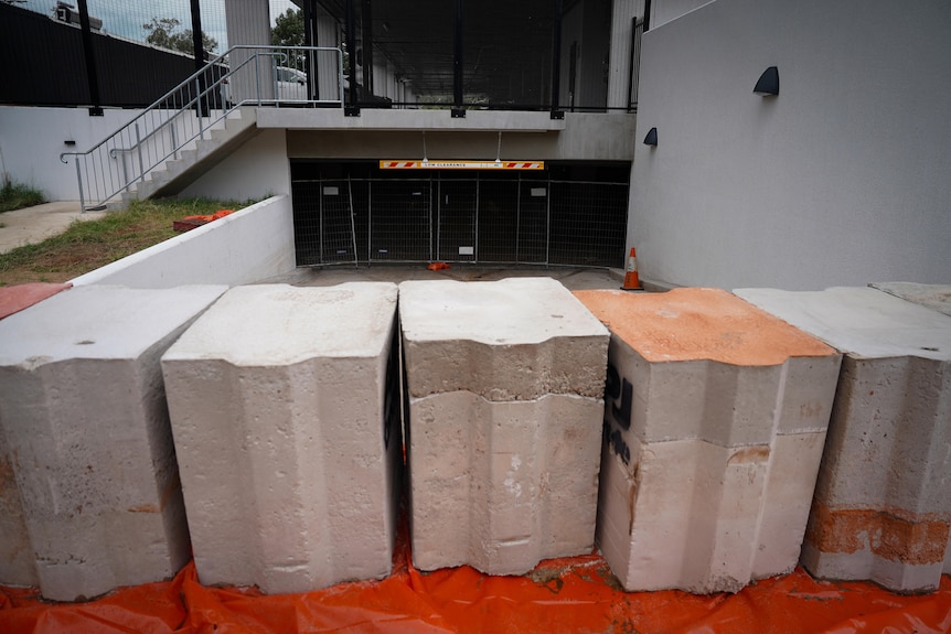 Cement bollards are lined up to protect buildings from flooding