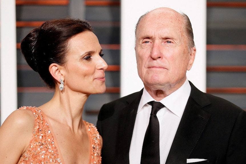 Actor Robert Duvall and wife, Luciana Duvall, arrive at the 2015 Vanity Fair Oscar Party.