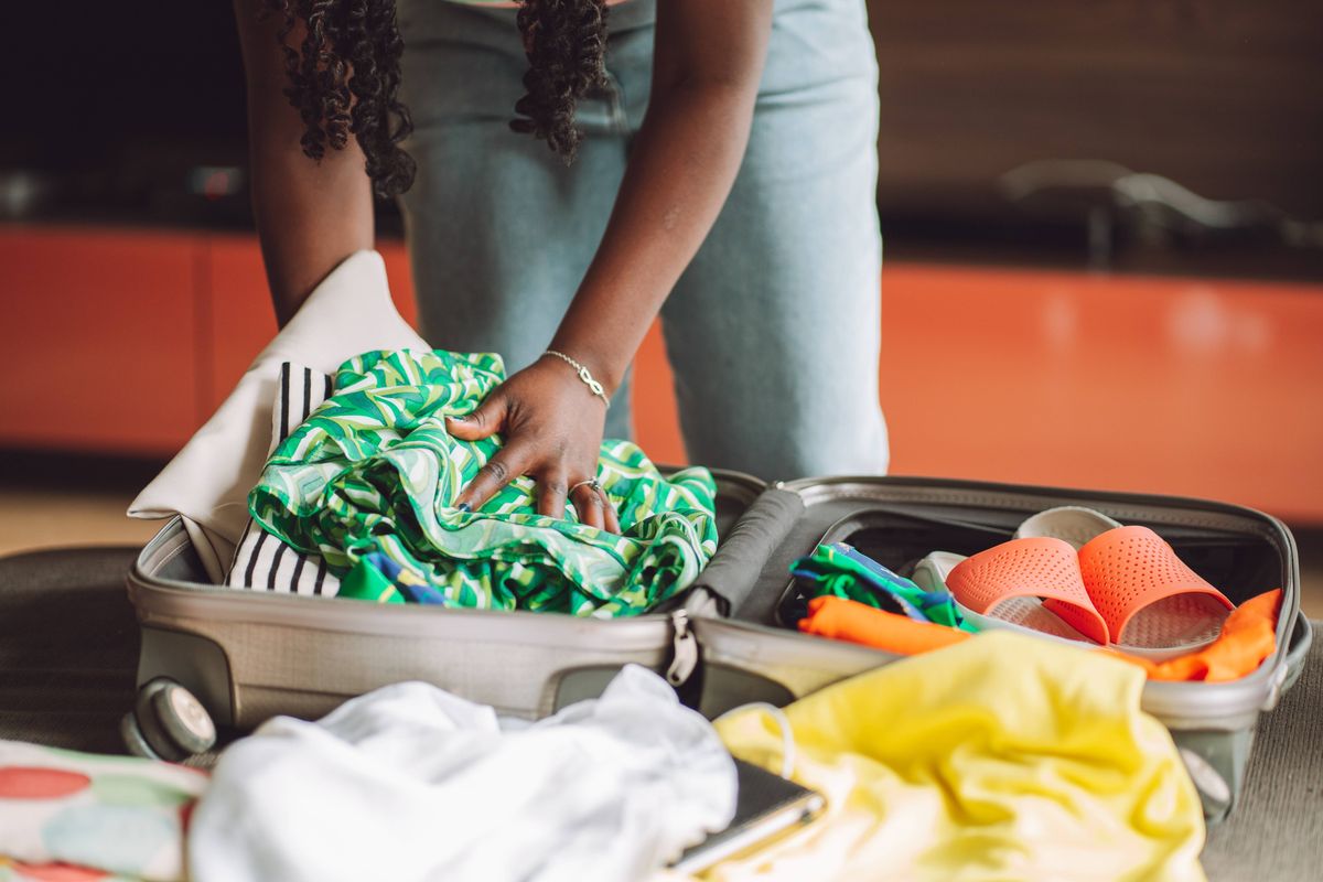 Woman packing her suitcase. 