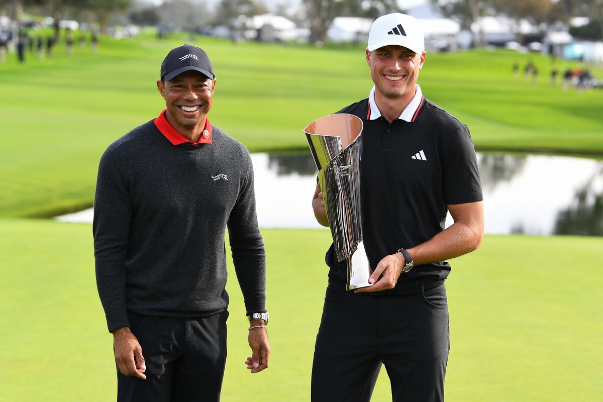 Tiger Woods poses with Ludvig Aberg, who is holding the trophy in 2025