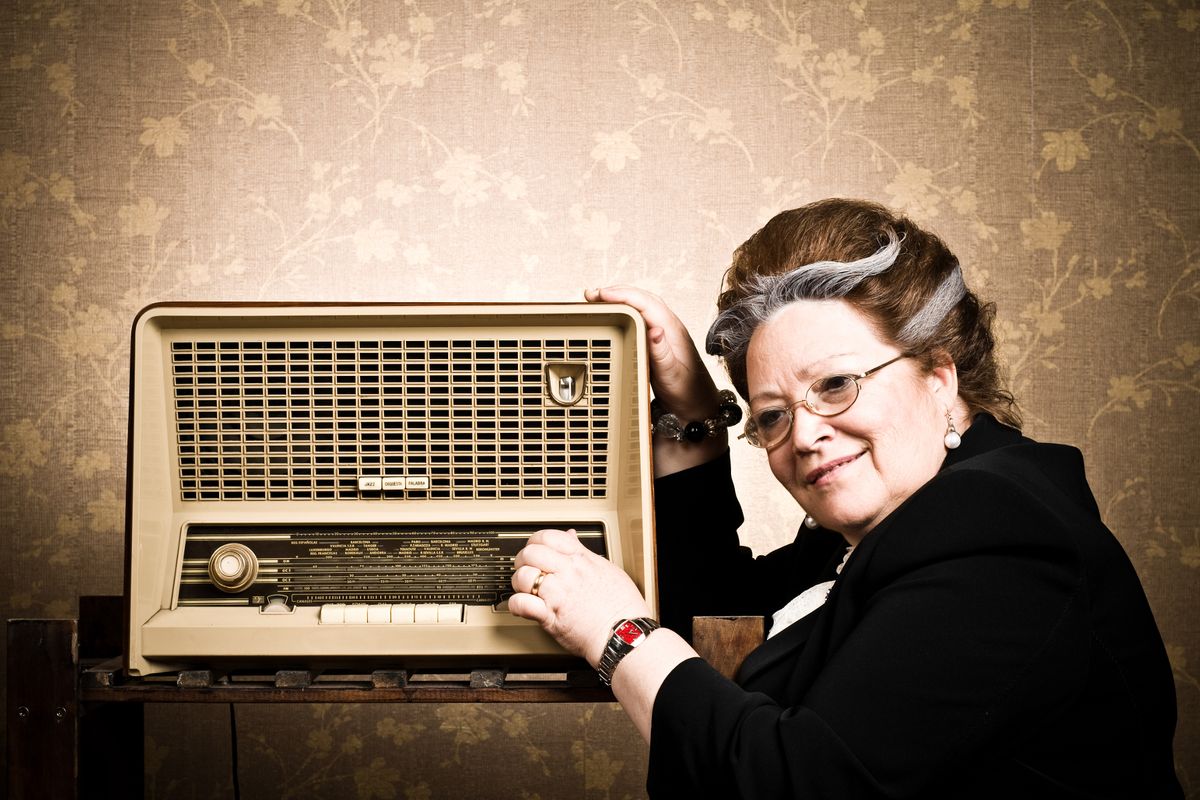 A woman listening to a radio