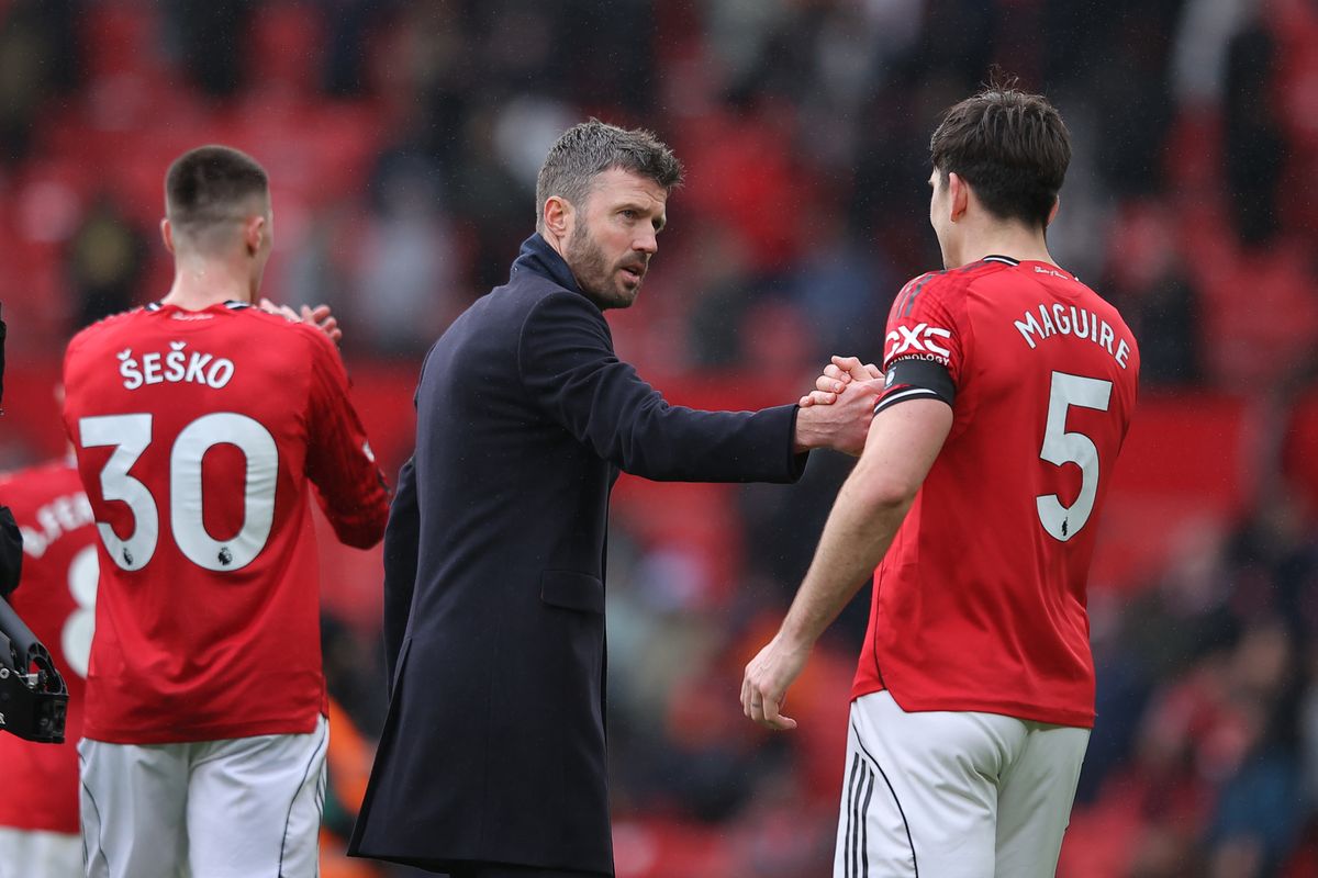 Michael Carrick, caretaker head coach of Manchester United, acknowledges Harry Maguire of Manchester United after the Premier League match between Manchester United and Tottenham Hotspur