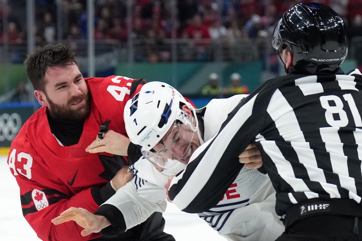 Canada's Tom Wilson (43) and France's Pierre Crinon, center, fight