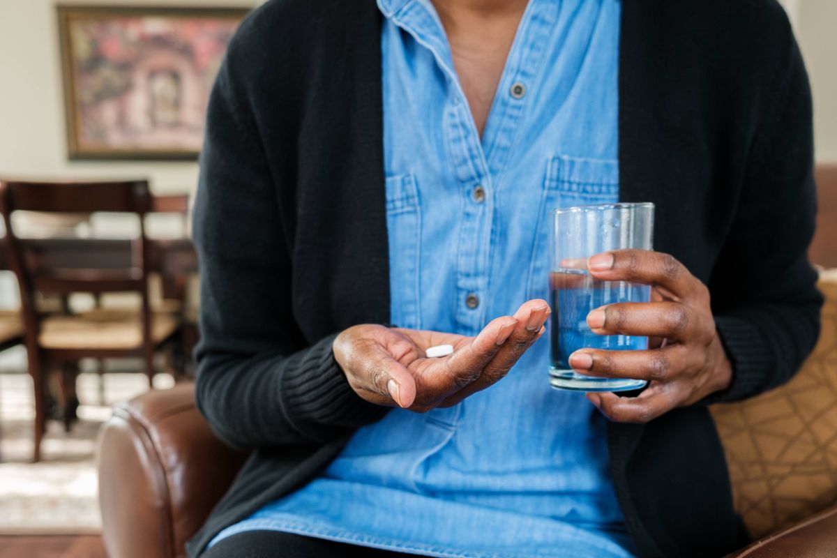 Close-up of unrecognizable black woman with her medication