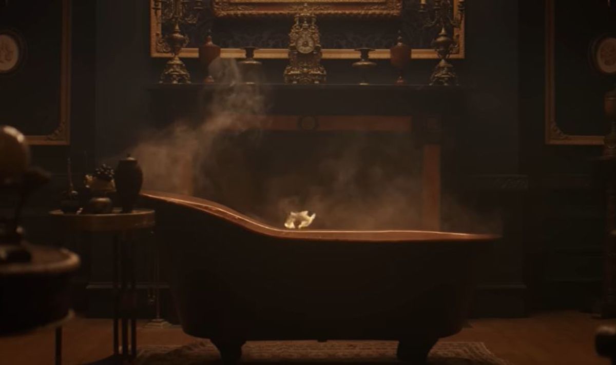 A steaming bath sits in the middle of an ornate room 