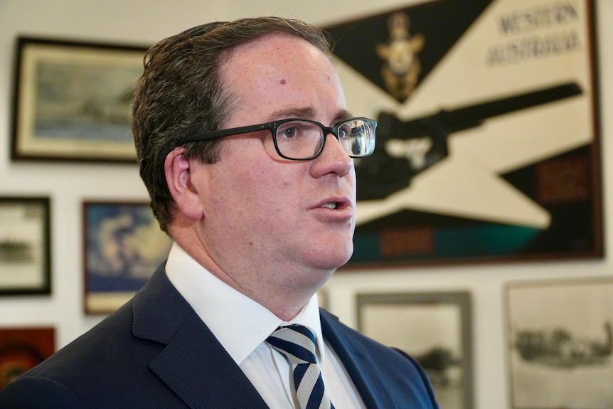 A close-up shot of a man with glasses