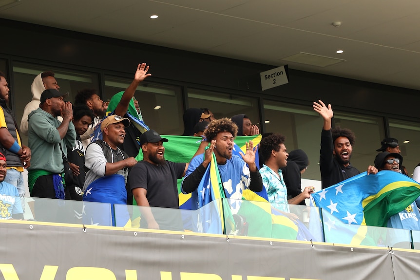 Solomon Kings fans cheer from the stands.