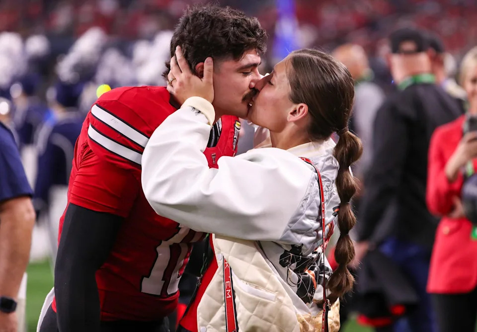 Texas Tech's Jacob Rodriguez shares a kiss with his wife Emma prior to the Big 12 Conference championship football game, Saturday, Nov. 6, 2025, at AT&T Stadium in Arlington.