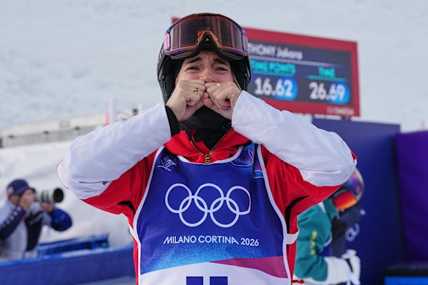 France's Perrine Laffont, center, reacts to winning the bronze medal after the last run from Australia's Jakara Anthony, back right, during the women's freestyle skiing moguls finals at the 2026 Winter Olympics, in Livigno, Italy, Wednesday, Feb. 11, 2026. (AP Photo/Gregory Bull)