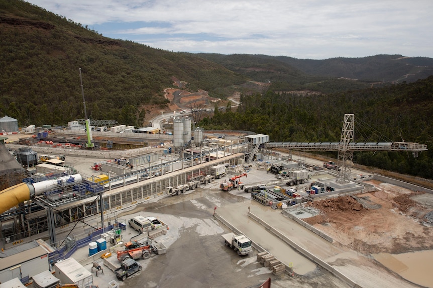A construction site nearby mountains. 