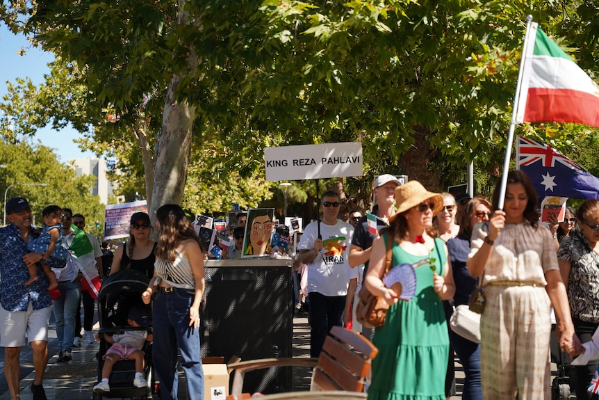 People walking holding signs and flags