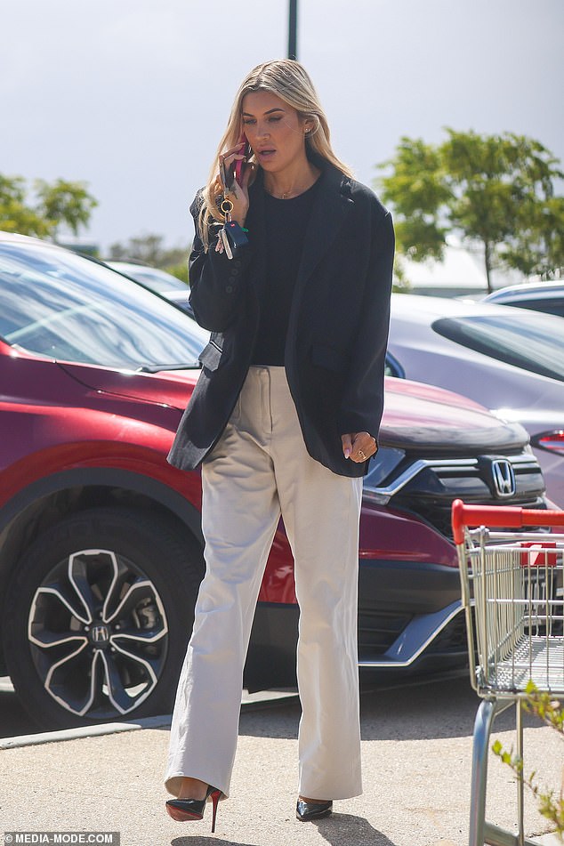 She completed the chic ensemble with towering black pointed heels featuring a flash of red on the sole, adding a glamorous edge to the otherwise corporate-inspired outfit