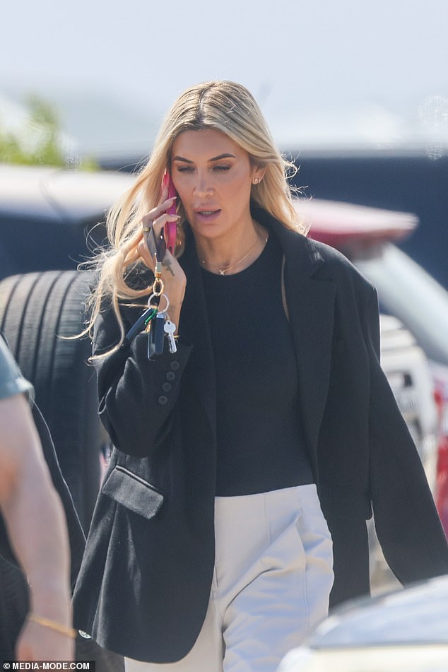 The blonde reality star cut a sombre figure as she emerged from a building clutching her phone, her expression serious as she took a phone call