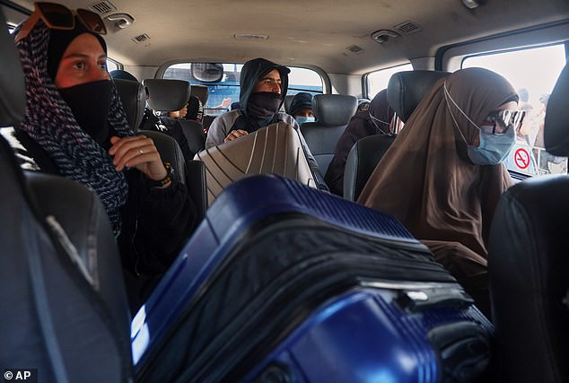 Kirsty Rosse-Emile is pictured, left, with other ISIS brides attempting to travel from Al Roj refugee camp, in Syria's northeast, to the capital Damascus last week