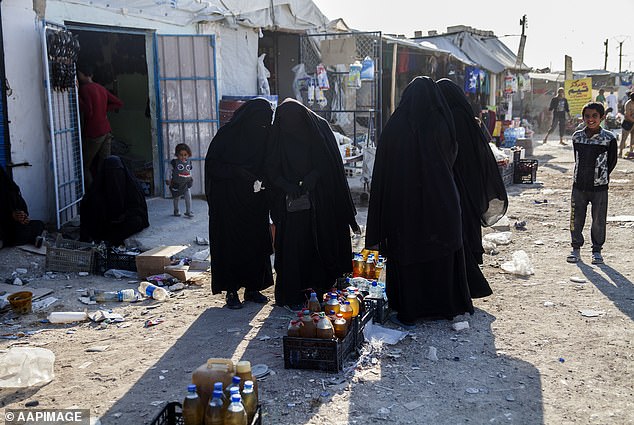 Pictured: Women buying food at the Iraqi market in Al Hawl refugee camp in Syria